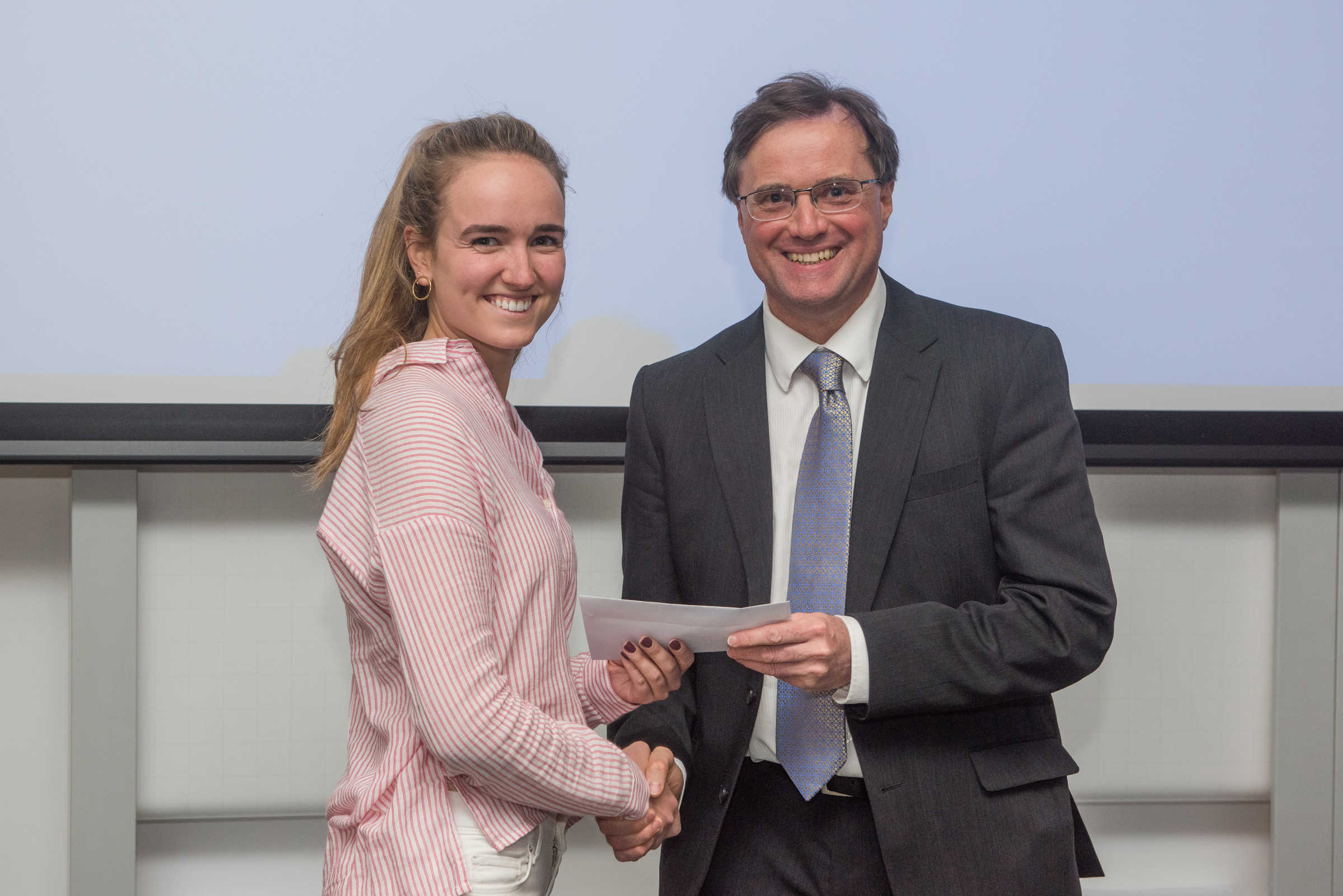 4th year student receiving her project poster prize at the lubbock lecture