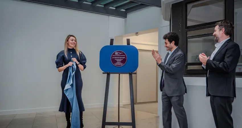 Dr Katerina Spranger, UKRI's Jonathan Grinbaud, and Head of Department Clive Siviour unveiling the new plaque