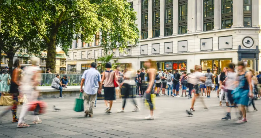 People walking around busy city