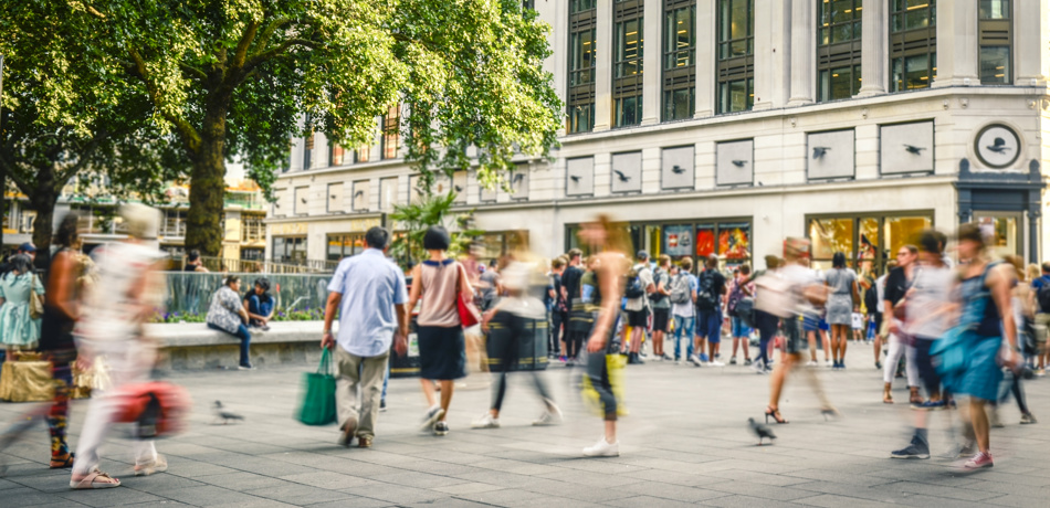 People walking around busy city