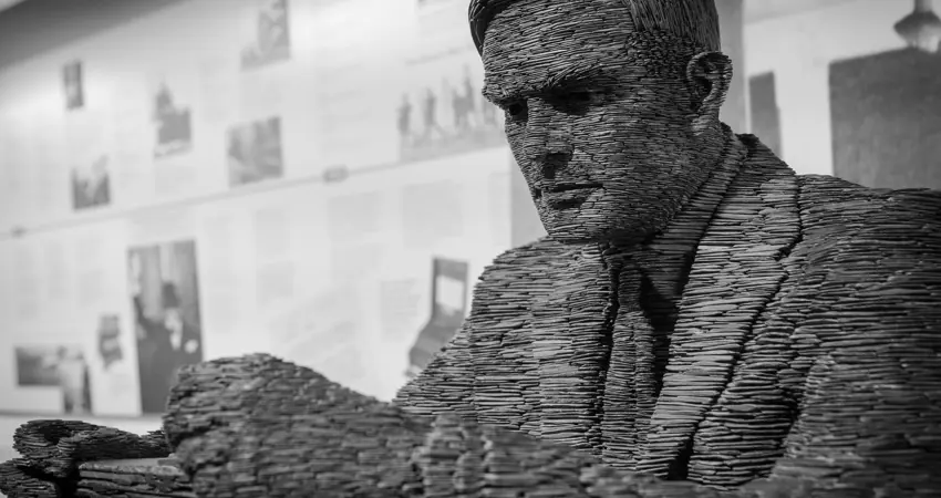 Male sculpture holding pile of papers