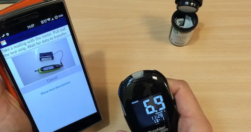 The GDm-Health app is designed to improve gestational diabetes management. Image shows a smartphone linked by Bluetooth to a blood glucose meter.