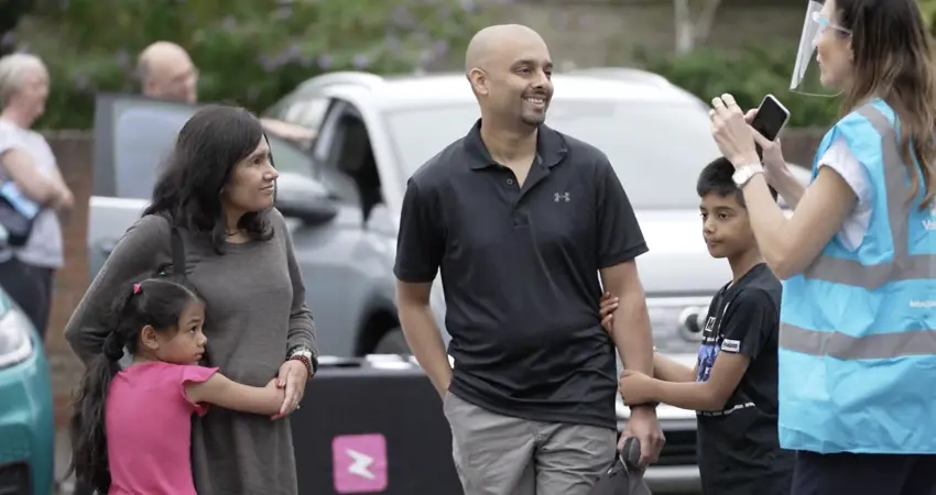 Group of people talking in car park