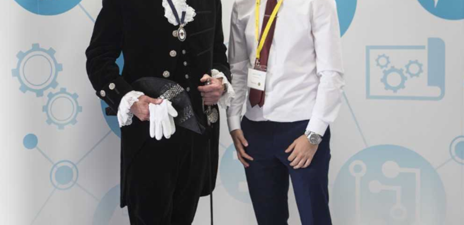 Two men posing at an awards ceremony.