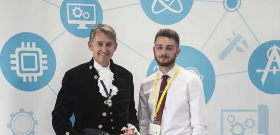 Two men posing at an awards ceremony.