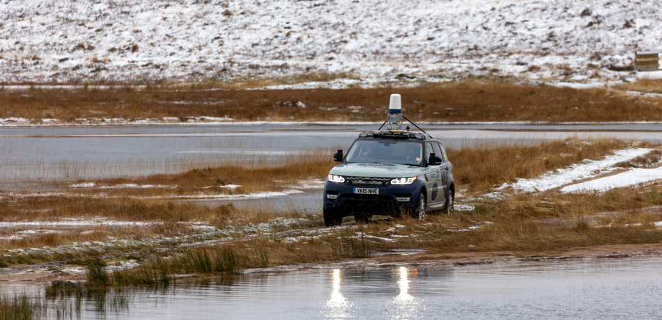 JLR Car crossing watery causeway.