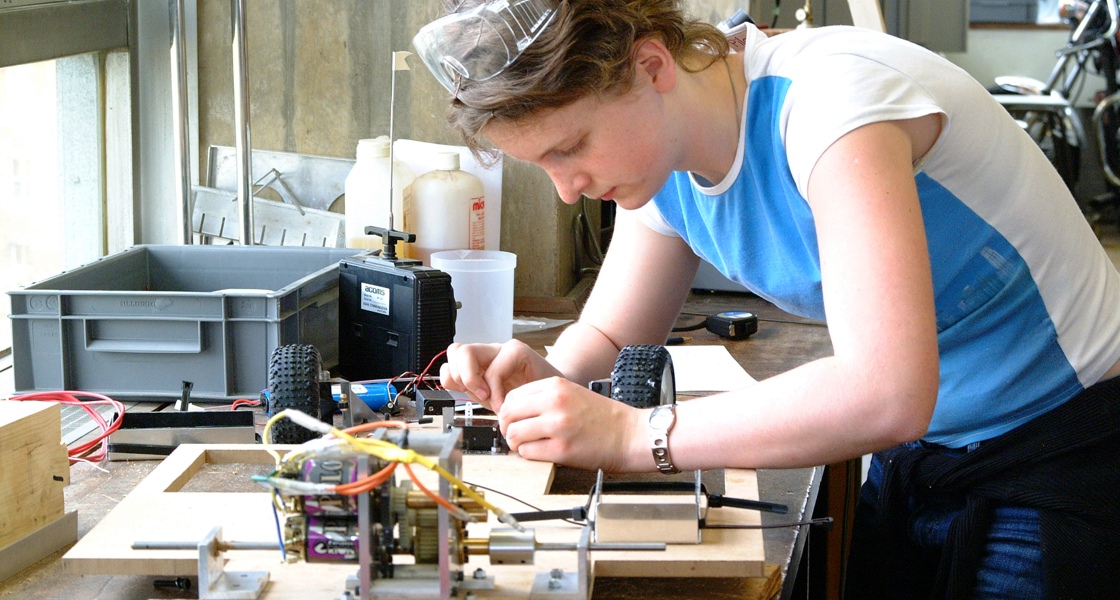 Young student in lab workshop working on electrical engineering project