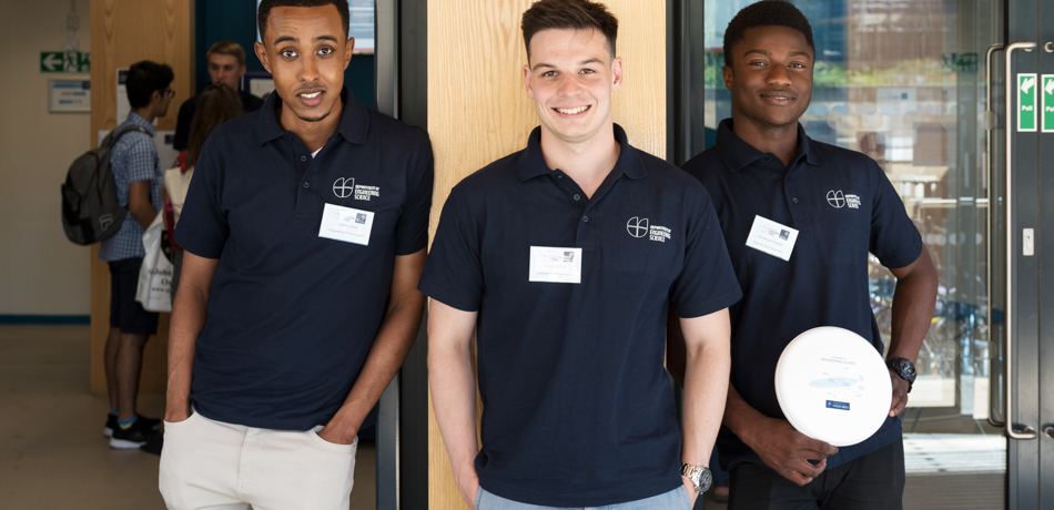 Three student ambassadors stood outside the Thom Building in branded Engineering Science polo shirts
