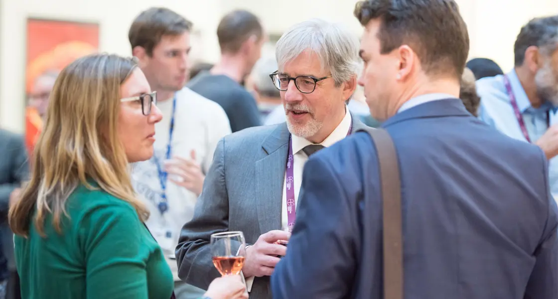 Professors Ron Roy and Constantin Coussios with alumna at an event
