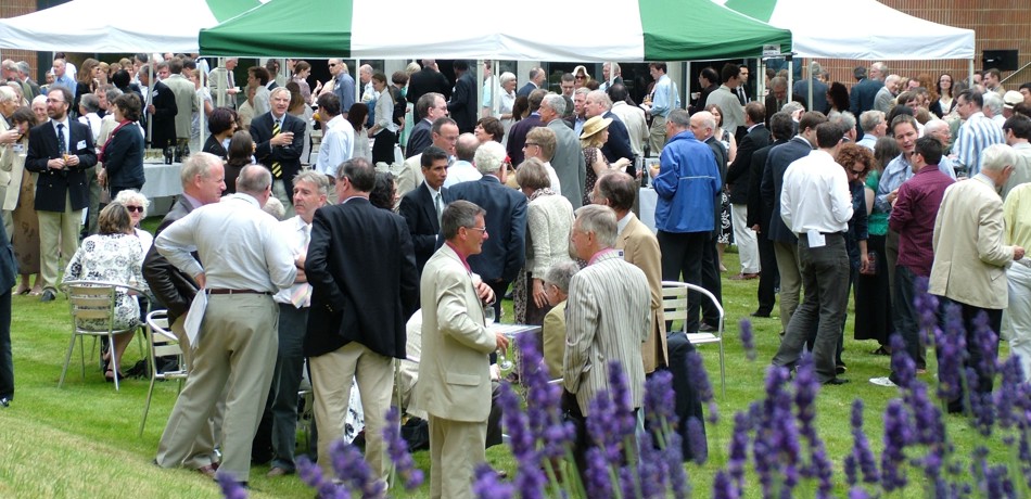 Centenary event, guests in college garden with marquee