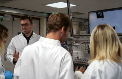 Professor Harrison Steel in his lab, working with students on their research.