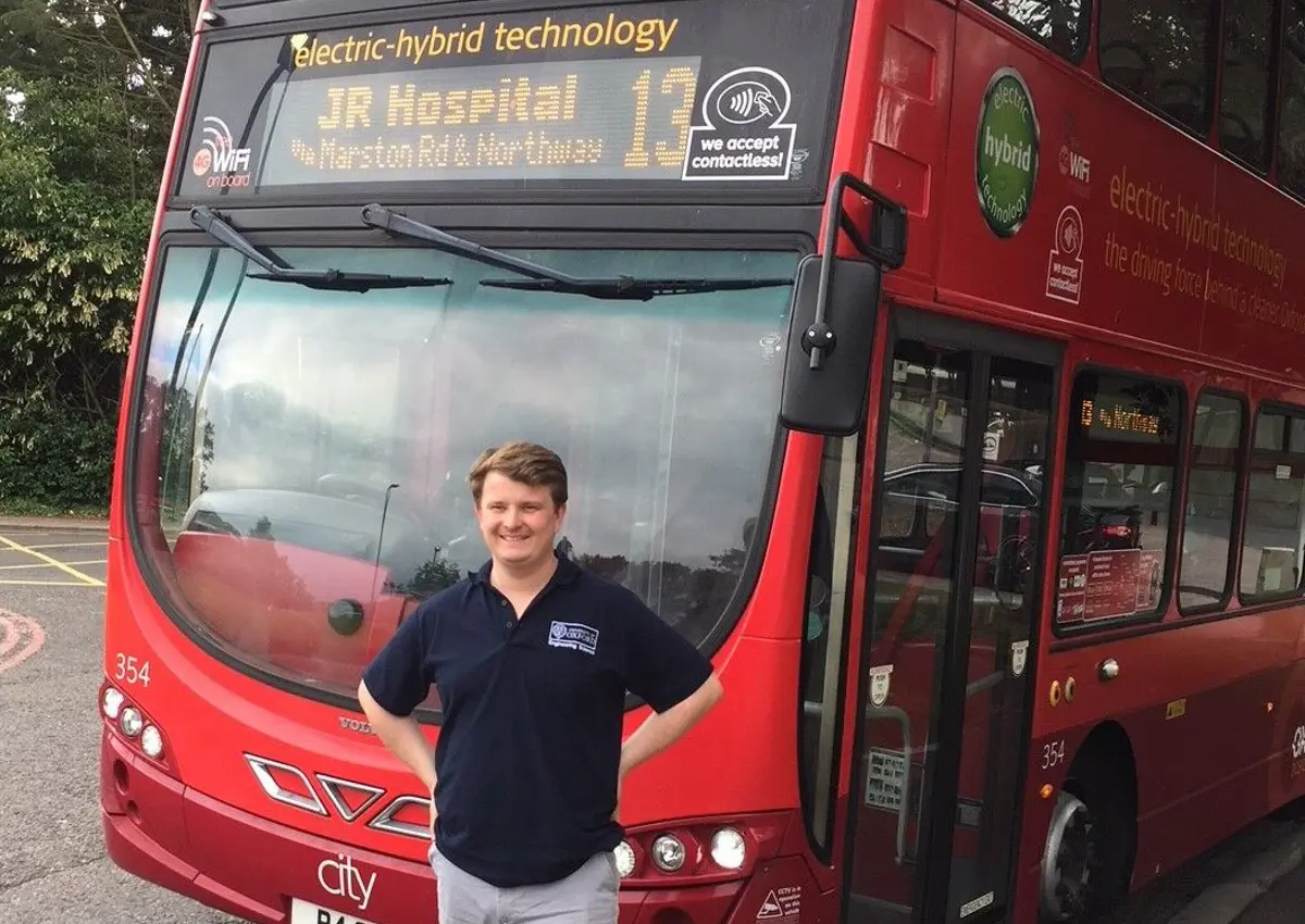 Professor Felix Leach standing in front of Oxford Bus Company no.13 bus used in the study