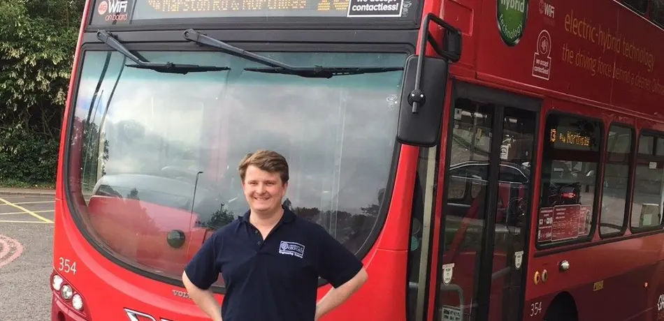 Professor Felix Leach standing in front of Oxford Bus Company no.13 bus used in the study