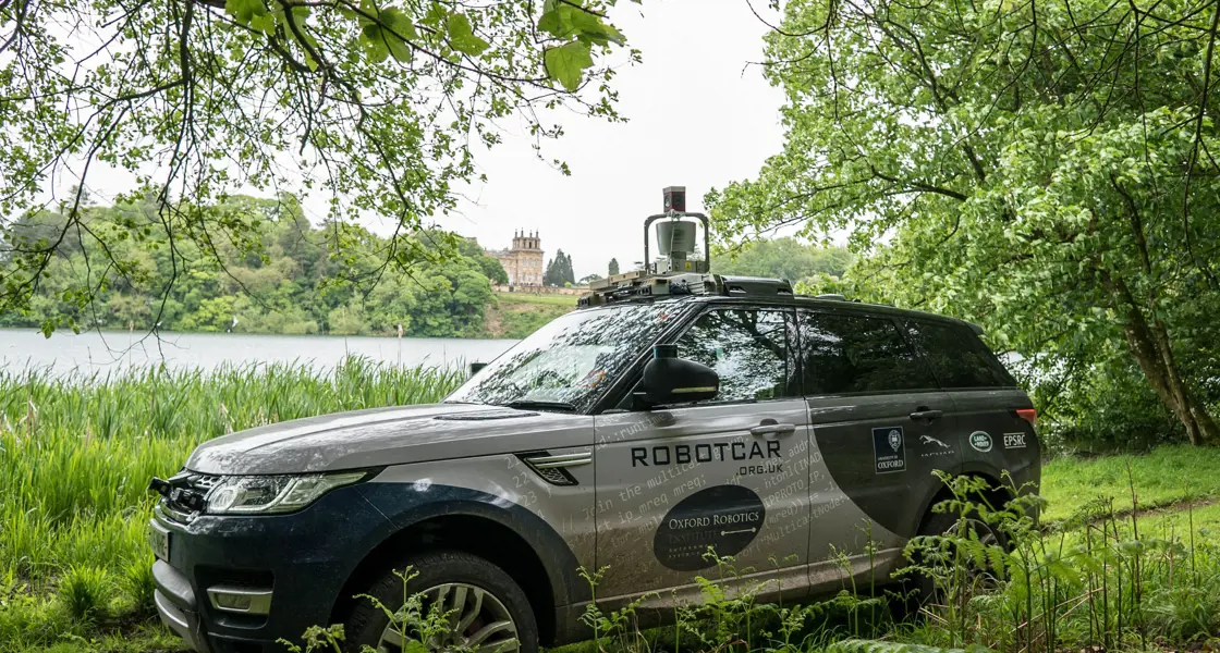 Oxford Robotics Institute vehicle offroad at Blenheim Palace with lake in background