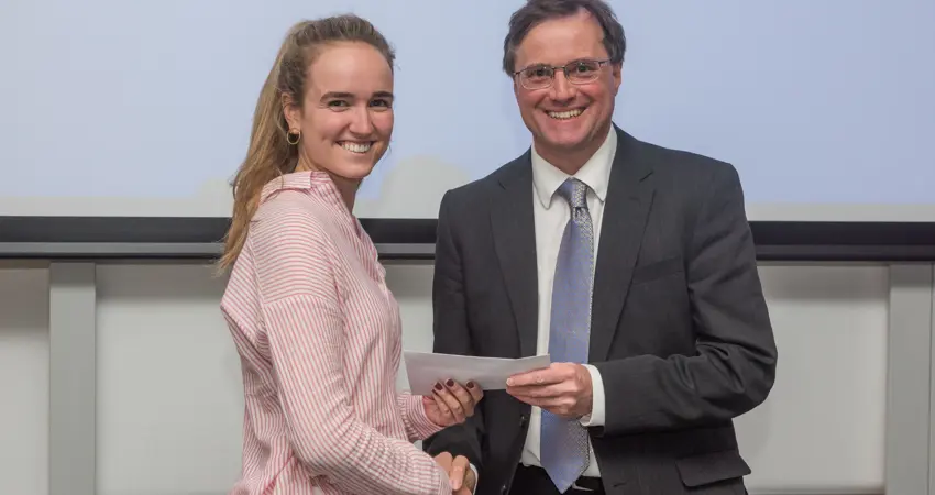 4th year student receiving her project poster prize at the lubbock lecture