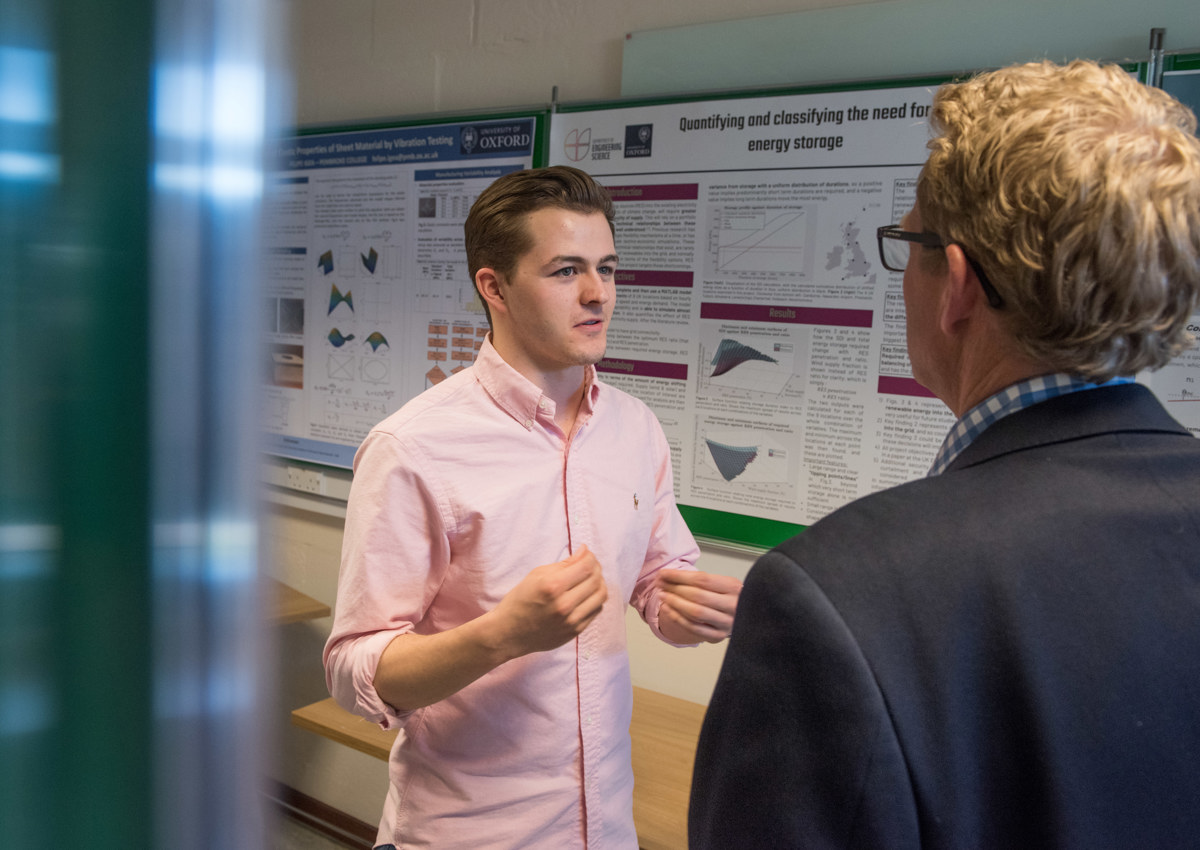 4th year student discussing his poster 