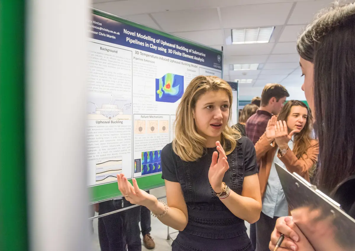 Student presenting her academic poster to public