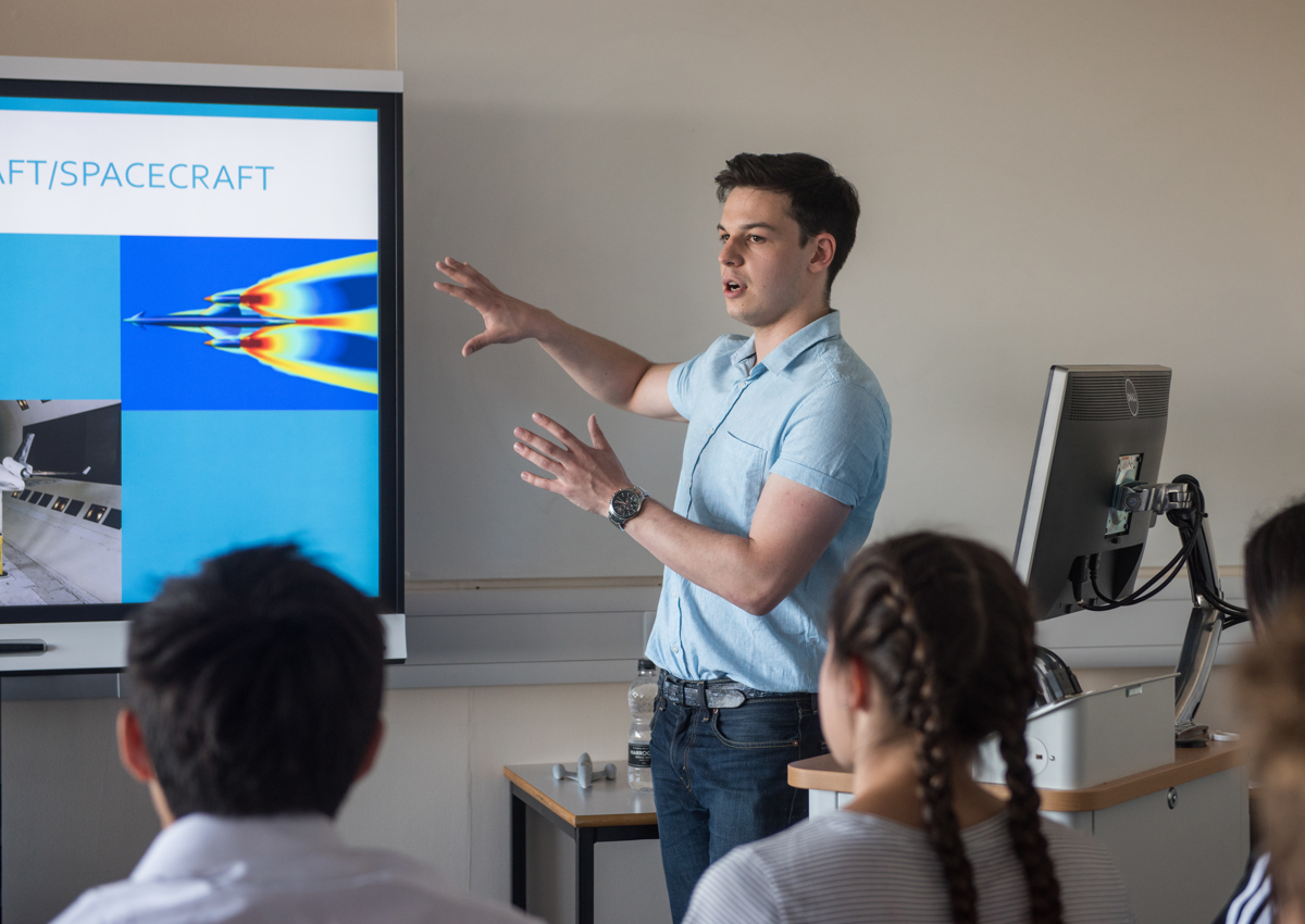 Student giving presentation on spacecraft