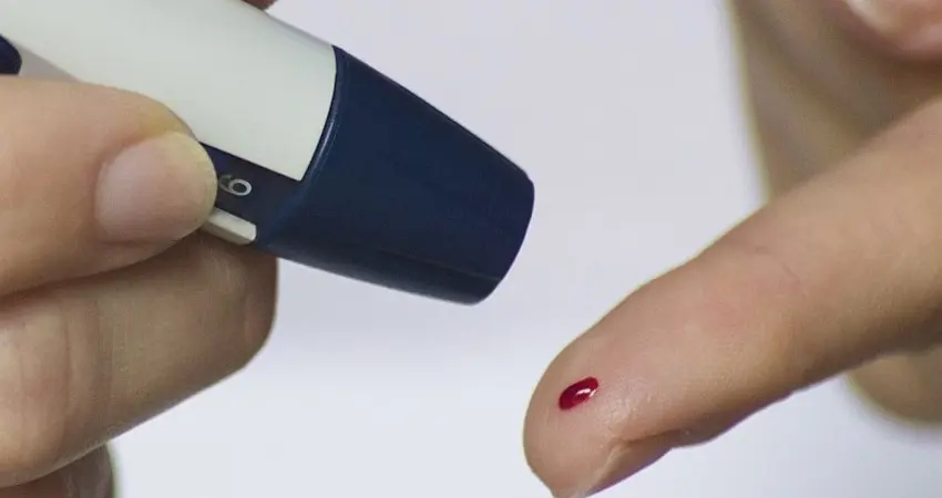 Stock image of finger prick blood test