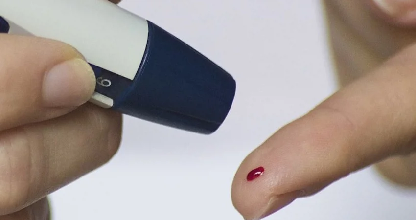 Stock image of finger prick blood test
