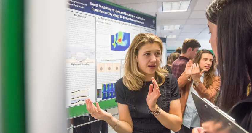 Participants discussing posters during the Engineering Lubbock Lecture