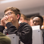 Close up of students in lecture theatre