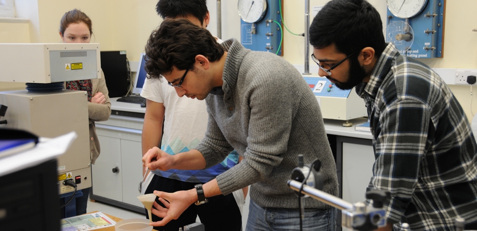 Group of students in lab working with soil sample