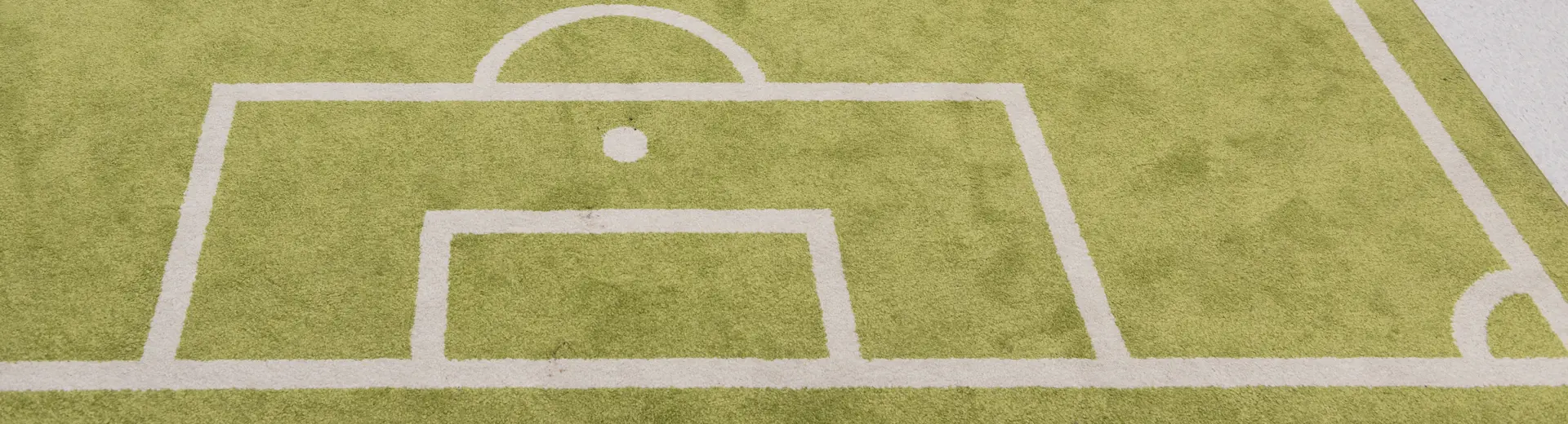 Very small robot on a miniature football pitch