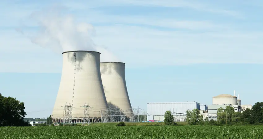 Big cooling towers in a factory in the countryside