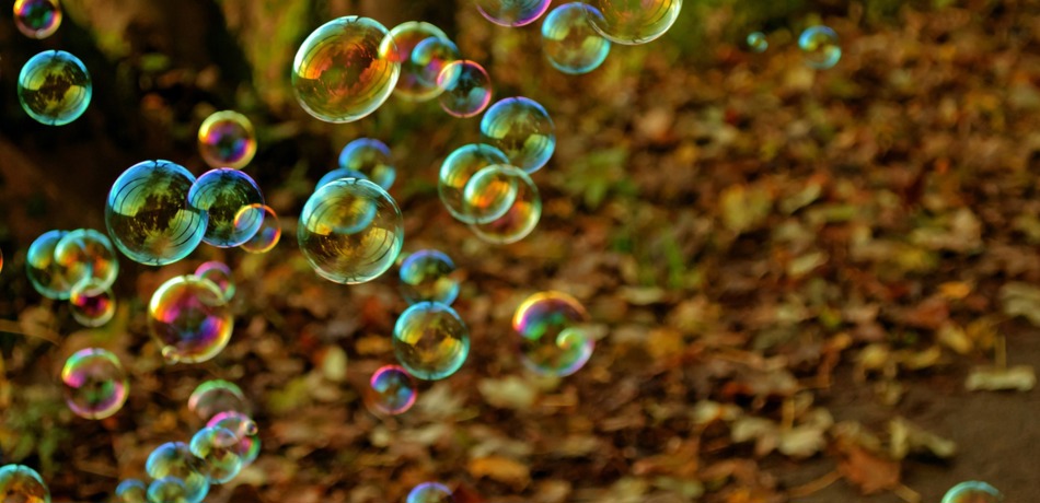 Lots of soap bubbles, and the ground is covered in autumn leaves