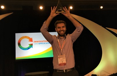 DPhil student Cristian Soitu holding aloft his trophy from the SLAS 2019 Conference