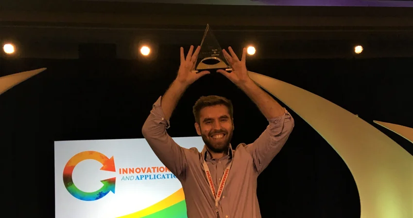 DPhil student Cristian Soitu holding aloft his trophy from the SLAS 2019 Conference