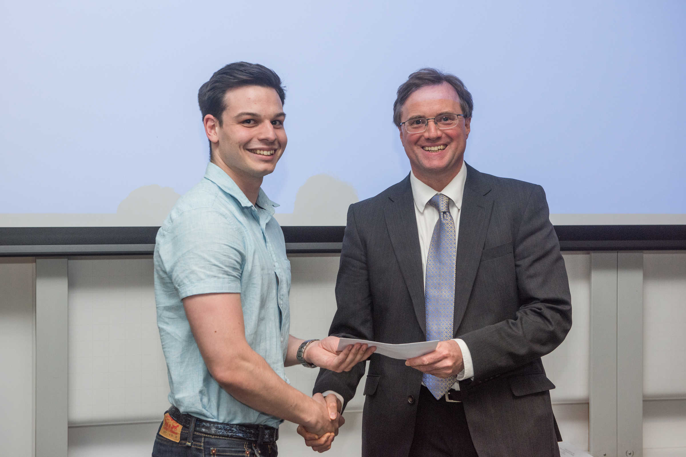 4th year student receiving his project poster prize at the lubbock lecture