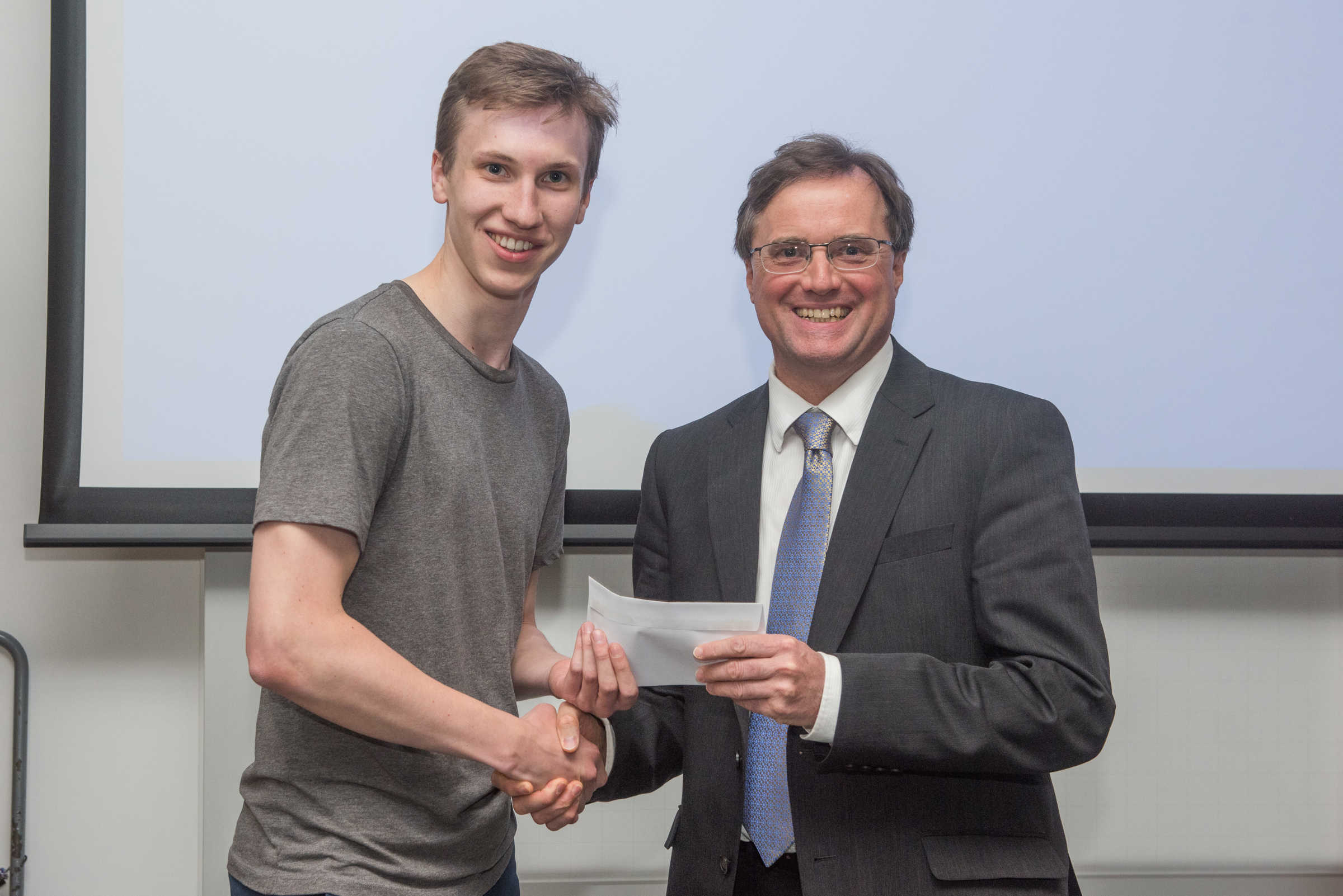4th year student receiving her project poster prize at the lubbock lecture