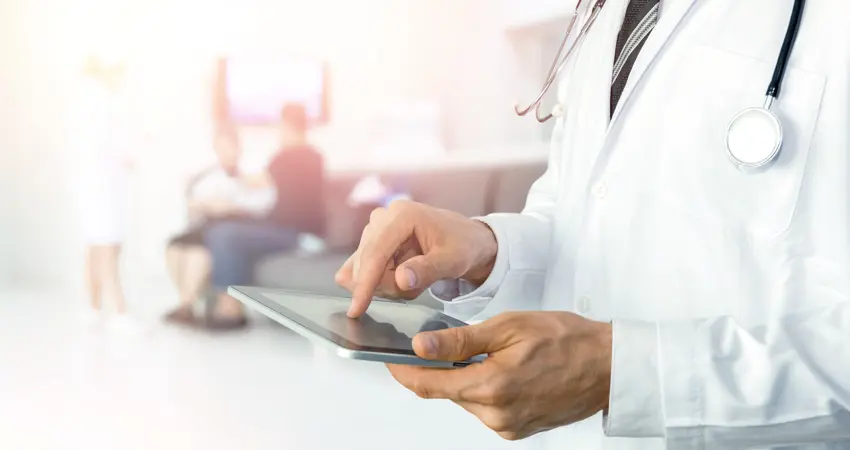 Stock image of medical professional using a tablet