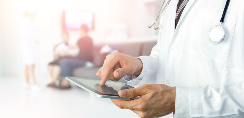 Stock image of medical professional using a tablet