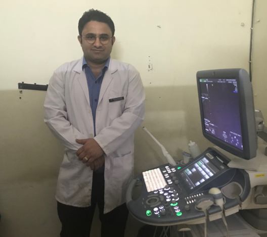 Medical professional next to ultrasound machine