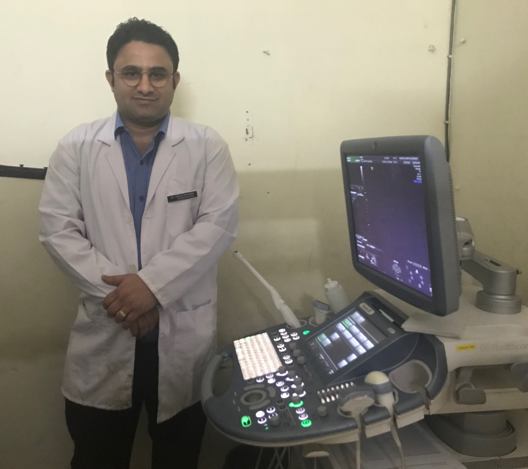 Medical professional next to ultrasound machine
