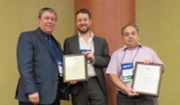 Three people displaying their certificates