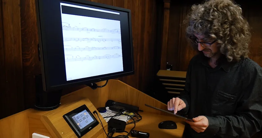 David Lewis setting up the string quartet live rehearsal annotation app for Digital Delius