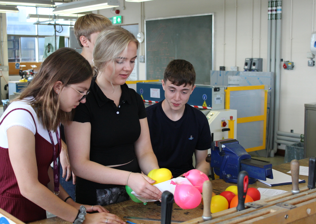 School students in workshop using balloons