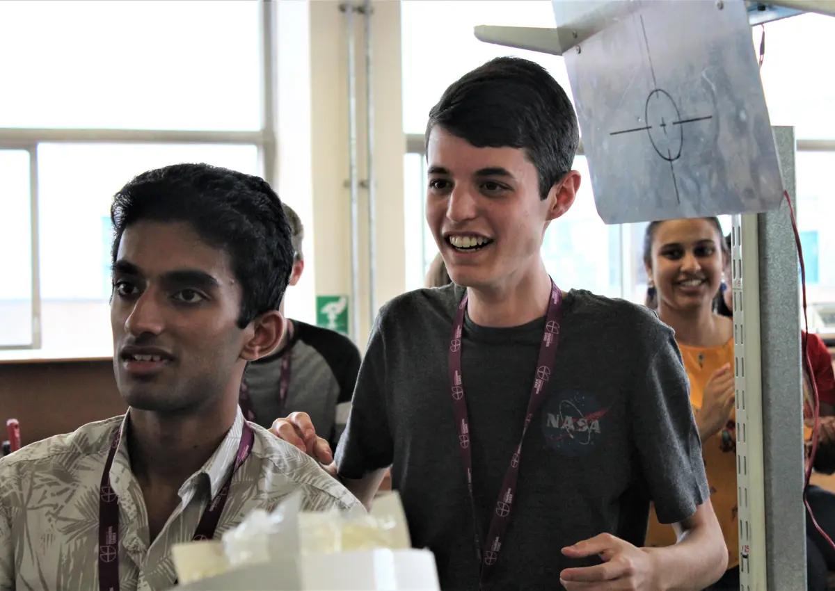 Excited school students in workshop