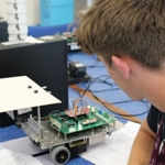 Student looking at robot