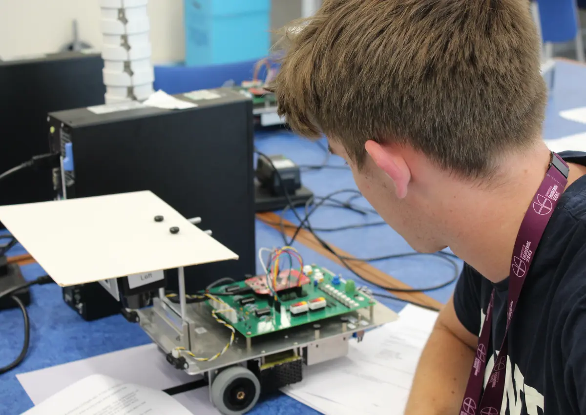 Student looking at robot