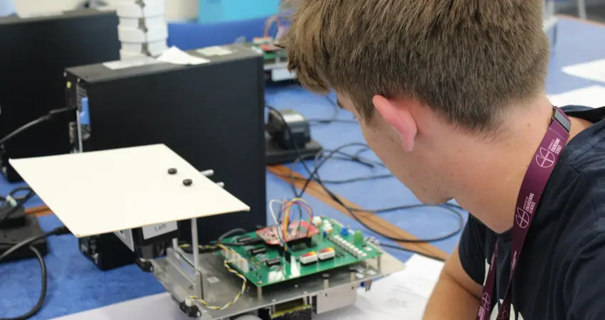 Student looking at robot