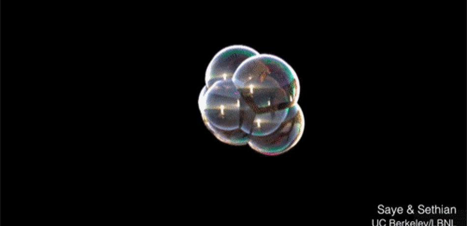 Bubbles combing over time on a black background