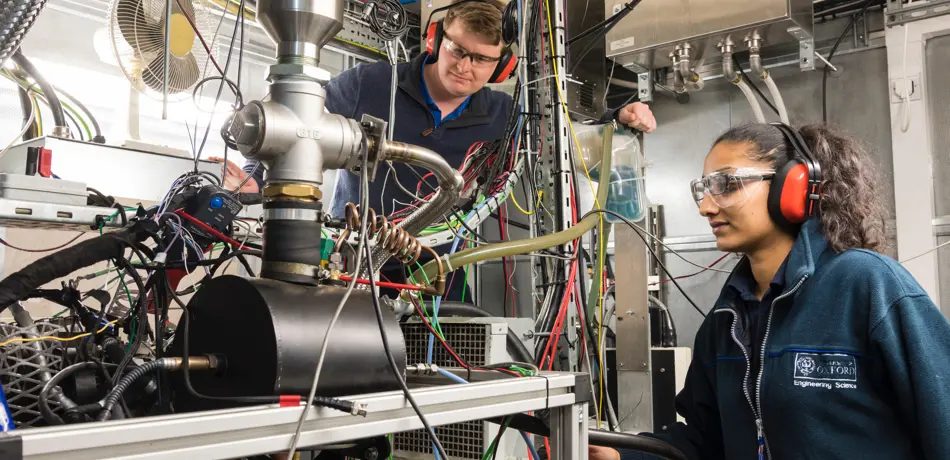 Students in a lab wearing protective hearing and safety glasses