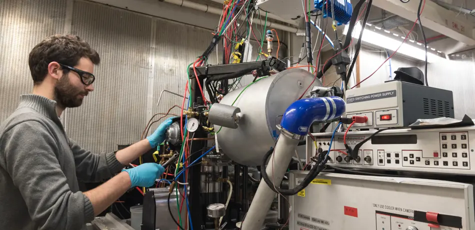 Researcher working on equipment in lab