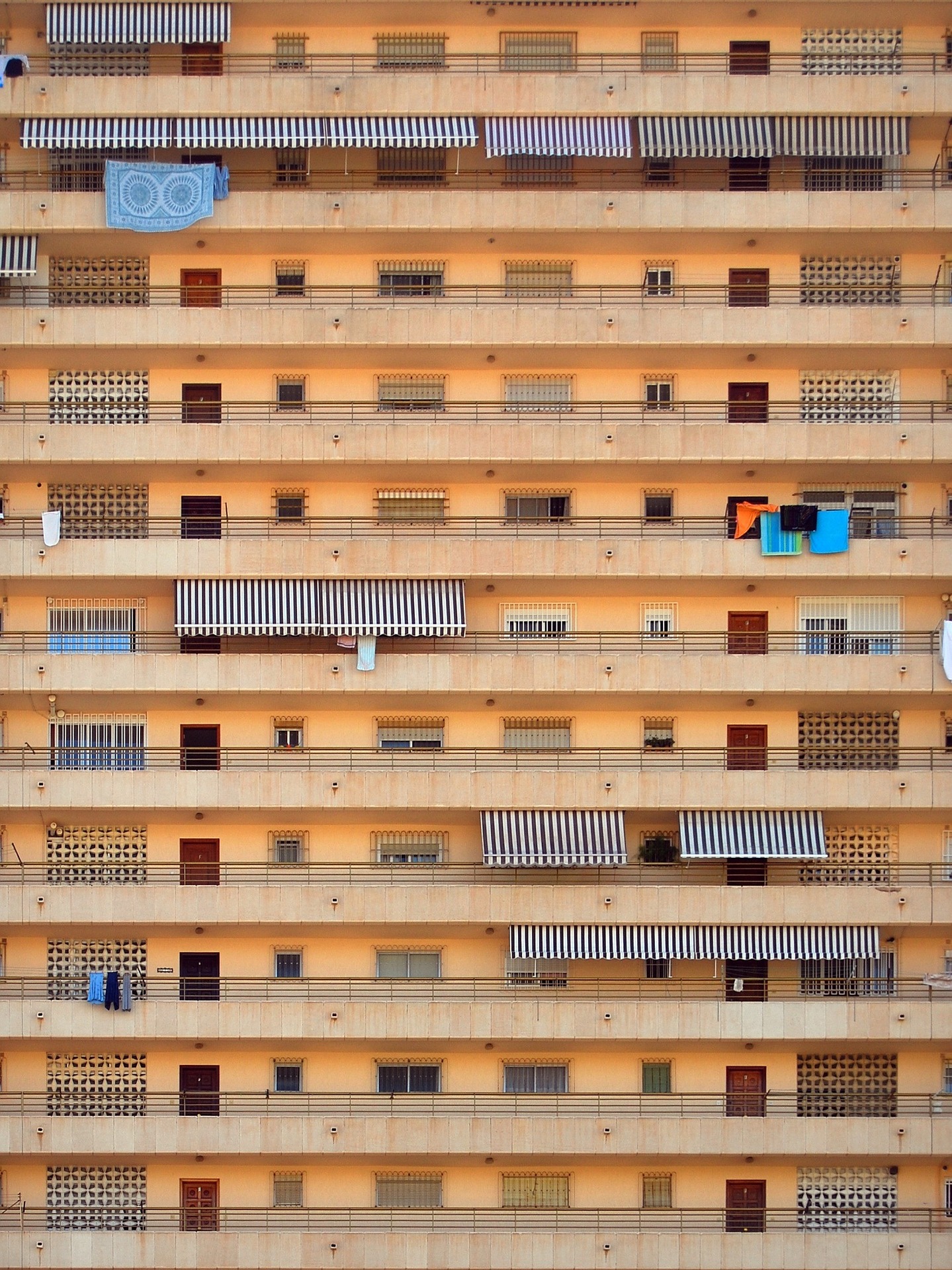 Several balconies of an apartment block in a hot country