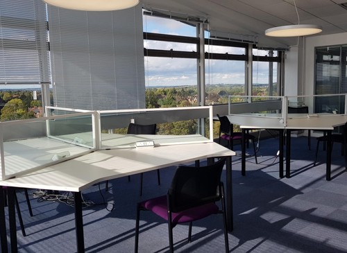 Student study area. Triangular desks with chairs and large windows with view of Oxford